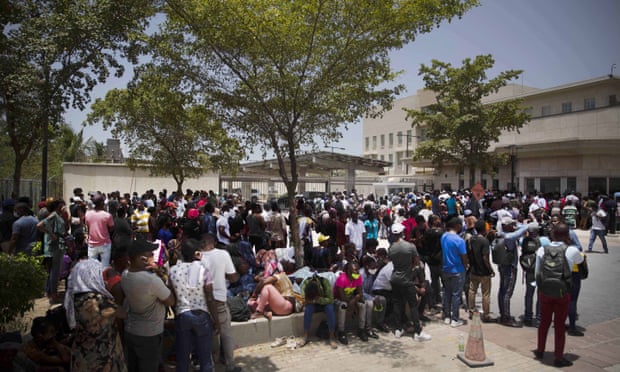 People gather in front of the US embassy in Port-au-Prince, Haiti, on Friday.