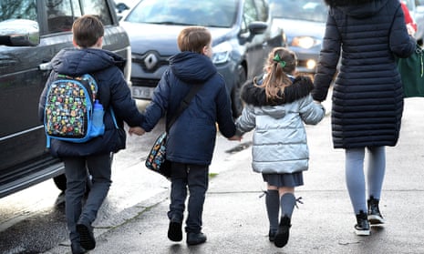 parent walking their children to school