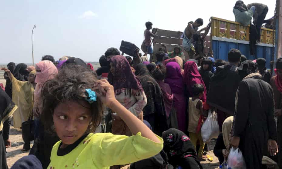 Rohingya refugees gather after being rescued by the Bangladeshi coastguard on Thursday. They had been drifting for weeks after failing to reach Malaysia.