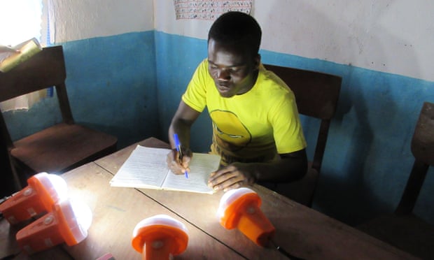 Working by the light of solar lamps at St Martin’s school in Nambuma, Malawi, July 2015.
