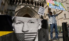 A protester. holds up a 'Free Julian Assange' banner outside the high court in London