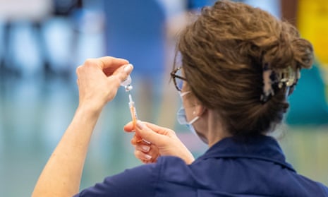 A nurse prepares a dose of the Oxford/AstraZeneca Covid-19 vaccine at an NHS vaccination centre in Epsom, Surrey