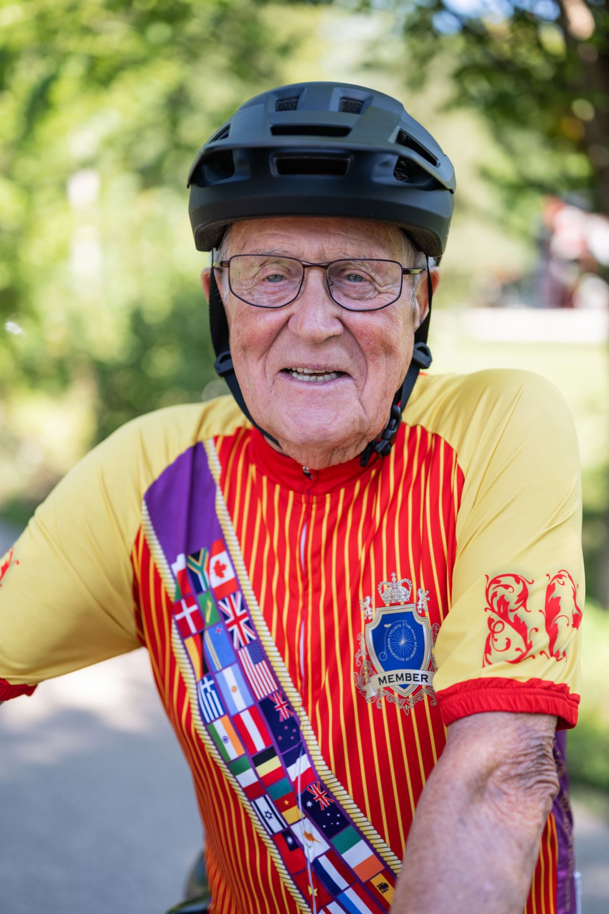 A closeup of Plummer in a cycling jersey and black helmet