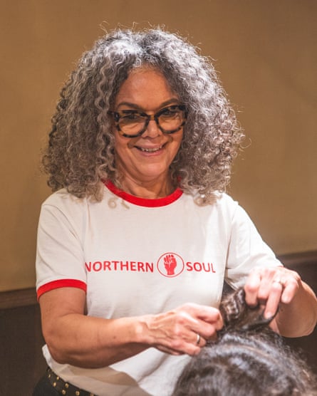 Stylist Jennie Roberts combing through a client’s hair