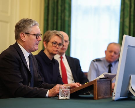 UK prime minister Keir Starmer sits with foreign secretary Yvette Cooper, defence secretary John Healey and chief of the defence staff Richard Knighton, while other participants attend by video link, as Starmer co-chairs the 'coalition of the willing' meeting at 10 Downing Street.