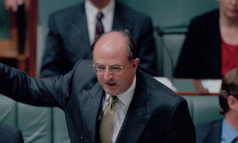 Peter Reith in parliament wearing a dark suit and fawn tie