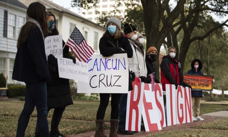 Demonstrators stand in front of Ted Cruz’s home in Houston demanding his resignation on Thursday.