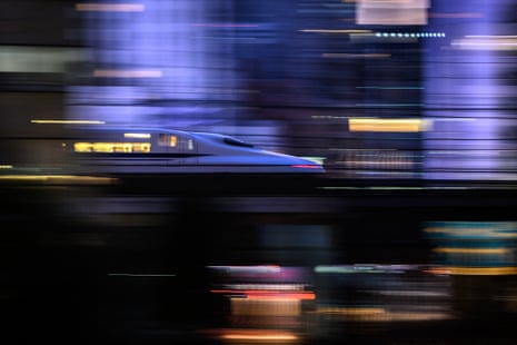 a bullet train passes through a city