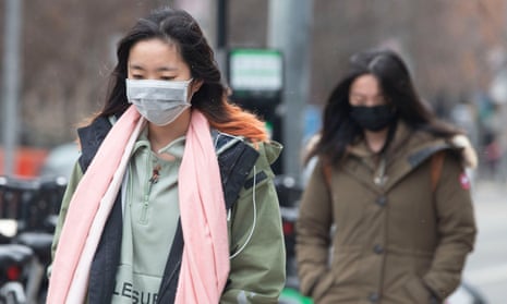 Pedestrians wear face masks as they walk in downtown Toronto Monday.