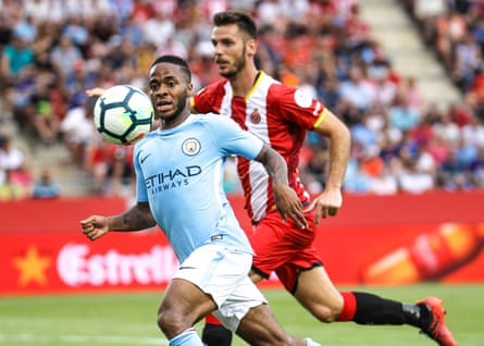 Raheem Sterling chases the ball with Alcalá in hot pursuit during Manchester City’s pre-season friendly against Girona