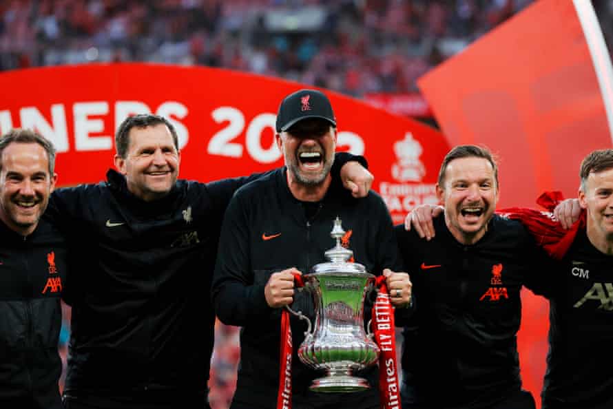 Liverpool manager Jürgen Klopp celebrates with the trophy and his backroom staff