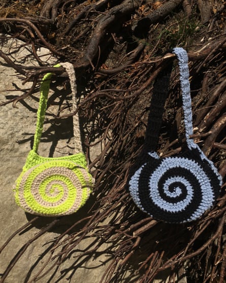 Two crochet bags featuring swirl patterns - one is neon yellow and grey, the other is blue and black.