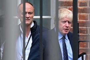 Boris Johnson and his special advisor Dominic Cummings leave from the rear of Downing Street before heading to the Houses of Parliament on 3 September.