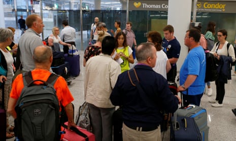 Passengers are seen at Thomas Cook check-in points at Mallorca Airport. Flights have been cancelled, leaving thousands stranded while on holidays after talks aimed at preventing Thomas Cook from going out of business throughout Sunday failed.