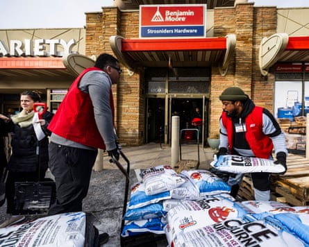 Hardware store employees restock bags of ice melt ahead of a winter storm in Bethesda, Maryland.