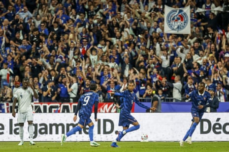 Michael Olise of France (second right) celebrates after opening the scoring against Italy.
