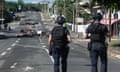 Police patrol a street blocked by debris and burnt out items following overnight unrest in the Magenta district of Noumea, New Caledonia.