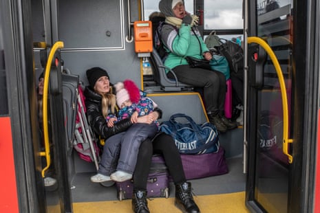 A Ukrainian woman and her daughter on a bus heading for Przemyśl train station near the Medyka border crossing, 28 February 2022