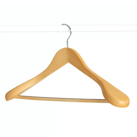 A John Lewis Suit Hanger in beech wood hangs on a white rod.