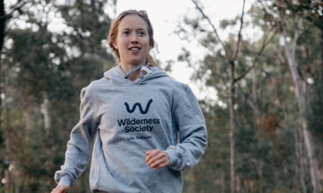 Australian ultrarunner Erchana Murray-Bartlett runs through the bush wearing a grey hoodie