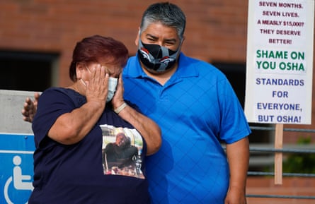 Carolina Sanchez, left, is comforted by her son, Saul, at a protest outside the Osha office in Denver. Sanchez’s husband, Saul, was the first worker to die of Covid-19 at the JBS plant in Greeley, Colorado.
