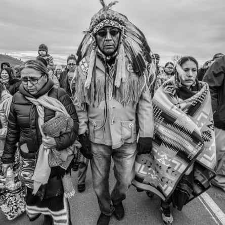 Chief Arvol and Paula Looking Horse and other water protectors walking away from a meeting with law enforcement on the Backwater Bridge at Standing Rock, with a prayer song.