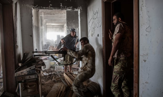 A fighter loyal to Libya’s Government of National Accord fires his weapon during fighting against Isis in Sirte.