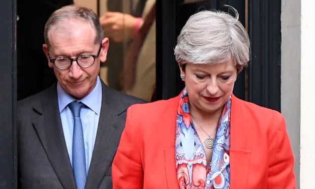 Theresa May leaves Conservative party headquarters with her husband Philip