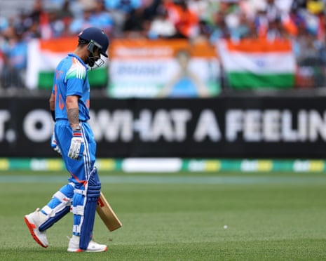 Virat Kohli walks from the field after being dismissed by Mitchell Starc