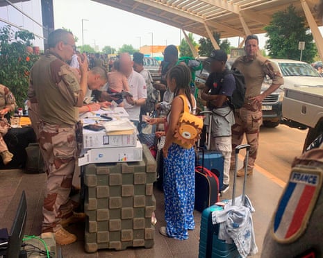 French military personnel register French and other European citizens outside the departures terminal of Diori Hamani international airport in Niamey