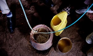 Men drink home brewed alcohol through straws in a bar in Kibera. Alcohol abuse in is deemed to be one of the major contributors to gender based violence and rape against women as well as fuelling violent crime.