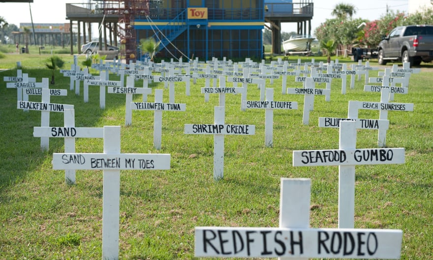 In this photo taken on 14 June 2010, crosses with descriptions of fish, wildlife and summer pastimes are displayed in a front yard of a home in Grand Isle, Louisiana, of things potentially lost to the BP Deepwater Horizon oil spill.