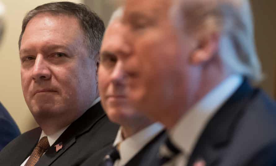Mike Pompeo listens with vice-president Mike Pence as Donald Trump speaks.