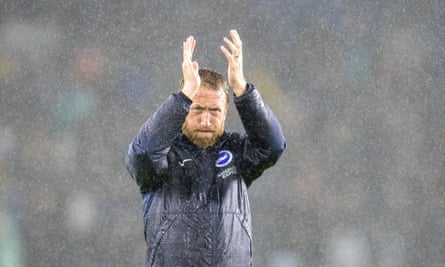 Graham Potter braves the downpour to thank Brighton’s supporters for doing likewise