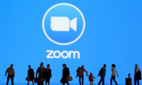 Small toy figures are seen in front of the Zoom logo