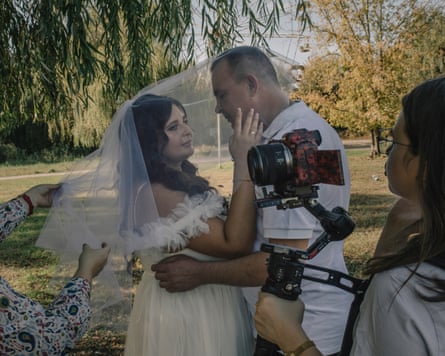 Newly-weds Petro and Olena pose for photographs in Sloviansk’s park. ‘I have a week off and then I return to the front,’ Petro, a Ukrainian soldier, said.