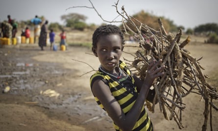 a girl gathers firewood in awerial, south sudan