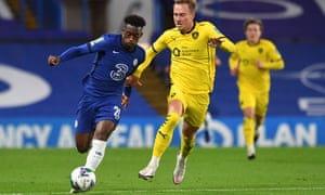 Callum Hudson-Odoi (left) bursts away from Barnsley’s striker Cauley Woodrow.