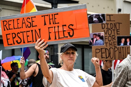 People holds signs calling for the release of files regarding Jeffrey Epstein in Houston, Texas, on 17 July.