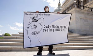 A protester holds a sign outside the US Senate East Front steps, on Capitol Hill today.