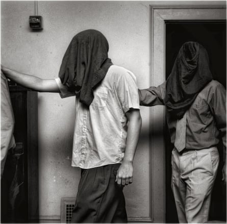 This photograph of hooded inductees recalls images of prisoners being degraded at Abu Graibh.
