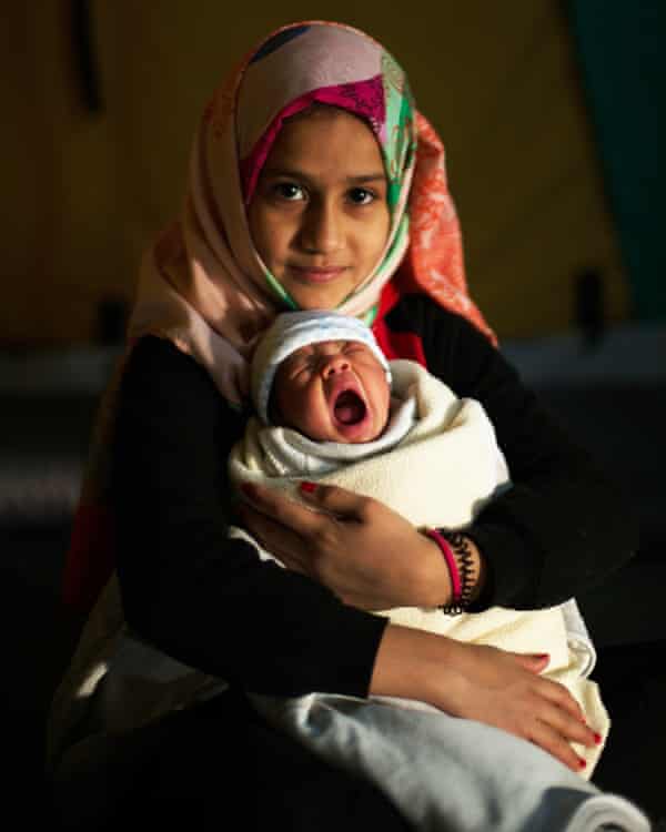 Yamamah Matlaq with her newborn cousin in the Oreokastro refugee camp near Thessaloniki.