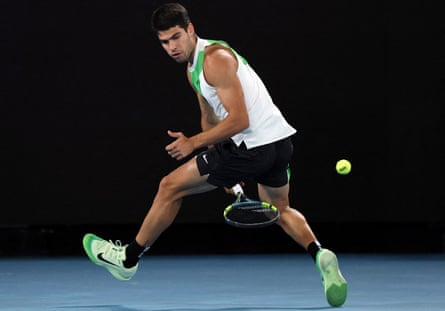 Carlos Alcaraz returns the ball to Novak Djokovic during the Australian Open final.