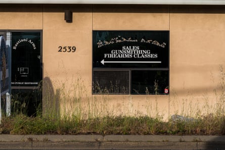 exterior of gun store, with sign in window saying ‘sales, gunsmithing, firearms classes’