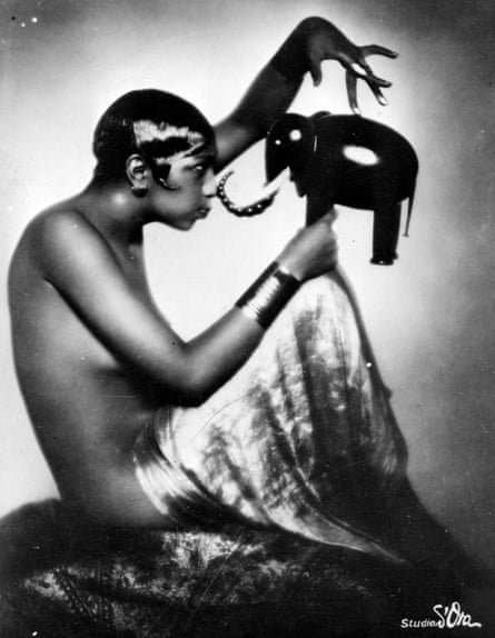 American dancer, singer and activist Josephine Baker poses with a model of an elephant.