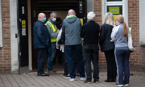 People queue outside a Covid-19 Vaccination Centre in Maidenhead for their booster jabs