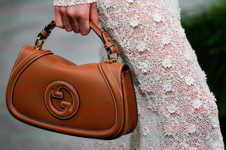 A tan handbag with Gucci’s double-G logo