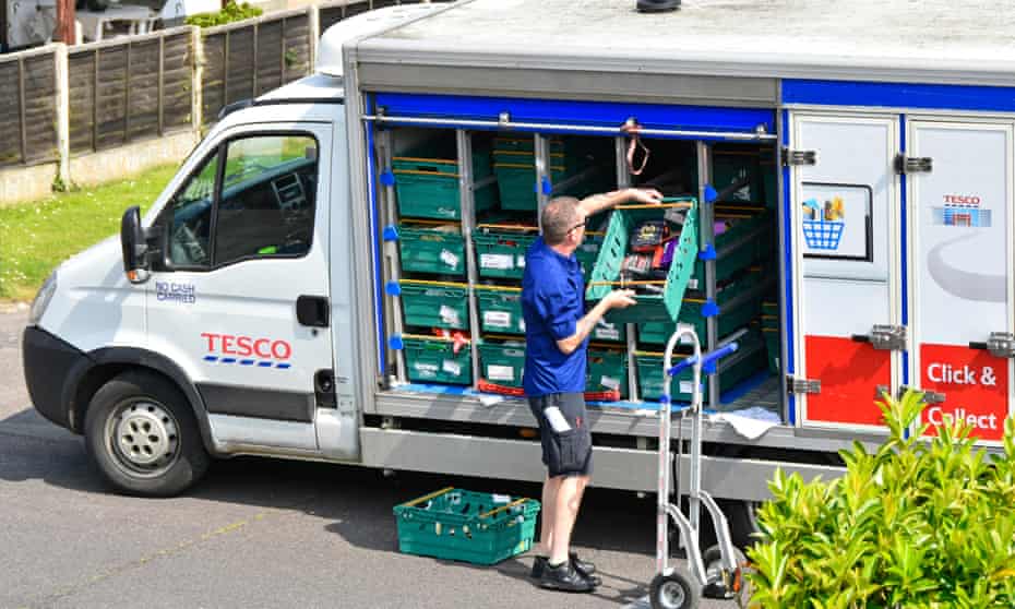 a tesco home delivery van driver unloads his vehicle