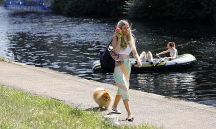 A woman walks with her dog near Queen Elizabeth Olympic Park in east London.