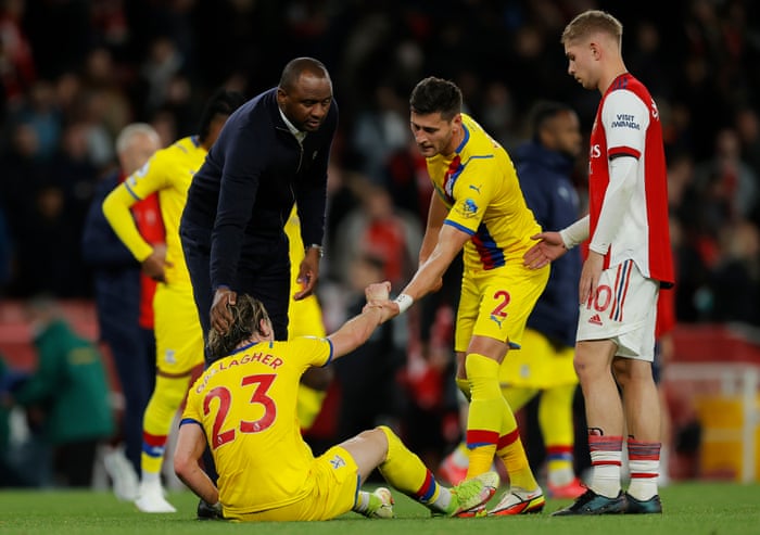 Patrick Vieira manager of Crystal Palace (left) and Joel Ward (no 2) help Conor Gallagher of Crystal Palace to his feet at full time.